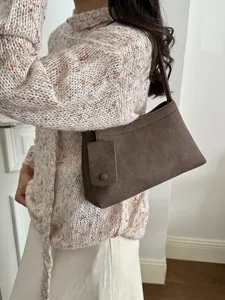 Detailed view of the vintage brown suede shoulder bag showcasing its premium texture and charm.
