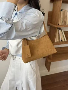 Retro suede shoulder bag for women, chic vintage underarm handbag with small pouch.
