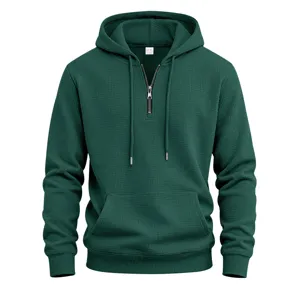 Close-up detail of the deep green waffle knit hoodie showcasing the front zipper and texture.