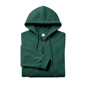 Detail view of men's dark green waffle knit quarter-zip hoodie with comfortable hood.