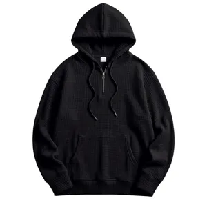 Men black waffle knit half zip hoodie close up detail showing textured fabric and collar.