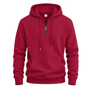 Men casual waffle knit half-zip hoodie with front pocket, textured fabric detail closeup.
