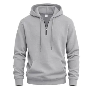 Mens grey waffle knit quarter zip hoodie detail showing textured fabric and drawstring.