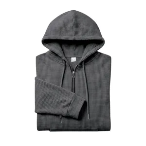 Men's dark gray waffle knit quarter zip hoodie detailed product shot showing texture.