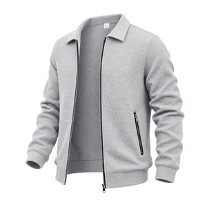 Detailed close-up view of the grey waffle knit jacket zipper and premium textured fabric.