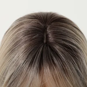 Close-up detail shot of synthetic wig scalp parting line with realistic gradient hair texture.