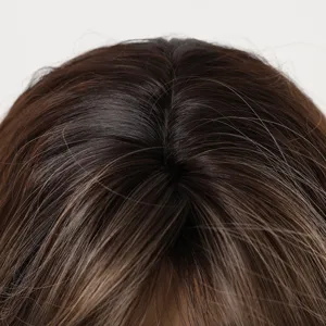 Close-up detail shot of synthetic gradient wig top with natural simulated scalp parting line.