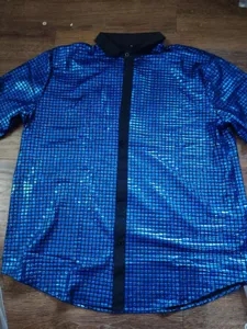 Close up view of the shiny sequin grid short sleeve shirt detail with black lapel collar.