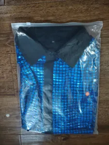 Detail view of men's disco sequin checkered short sleeve shirt in blue and black.