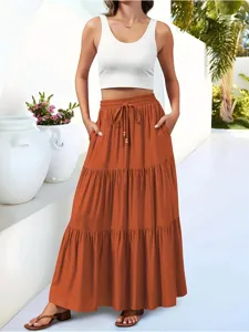 Detailed shot of the casual tiered maxi skirt with drawstring waist in resort outdoor style.