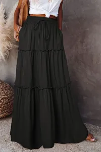 Detail view of black tiered maxi skirt with high waist drawstring and ruffles.