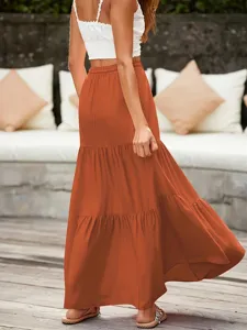 Detail shot of this casual tiered maxi skirt in rust orange, perfect for resort and summer styling.