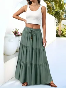Casual green tiered maxi skirt with high waist and drawstring, perfect for summer resort wear.