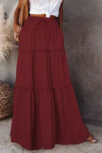 Detailed view of women high waist tiered maxi skirt in burgundy with delicate ruffle hem.