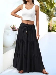 Casual black tiered maxi skirt with adjustable drawstring waist and chic wooden bead details.