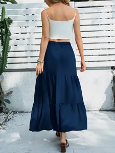 Detail shot of casual tiered maxi skirt worn outdoors with white crop top, scenic background.