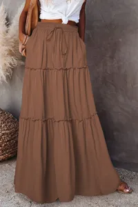 Detailed view of brown tiered maxi skirt featuring elastic drawstring waist and ruffle hem.
