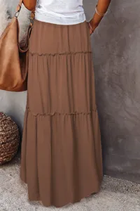 Close-up view of a brown tiered maxi skirt featuring delicate ruffle details and high waist.