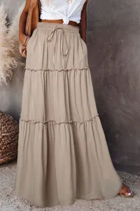 Detailed view of the tiered maxi skirt, featuring a high waist, drawstring, and ruffled layers.