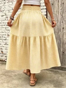 Detailed view of women's yellow gingham tiered midi skirt with comfortable elastic waist.