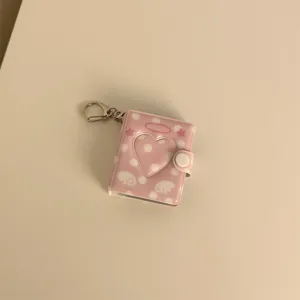 Pink mini photo album keychain with heart cutout and angel wings, cute 2-inch card holder.