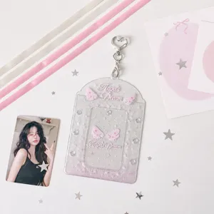 Tarjetero fotográfico de PVC transparente con cinta y alas de ángel para tarjetas de 3 pulgadas.
