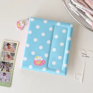 Detail view of a cute Korean style polka dot photo card binder with adorable pendant accessory.