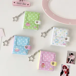 Detailed view of cute mini polka dot photo album card holders with star keychains in pastel colors.