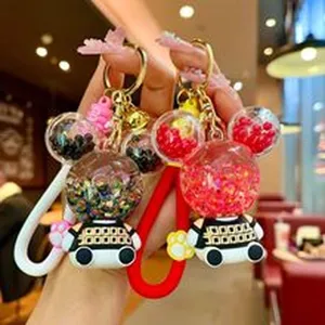 Detail view of cute cartoon character keychain with sparkling liquid glitter ears and silicone strap.