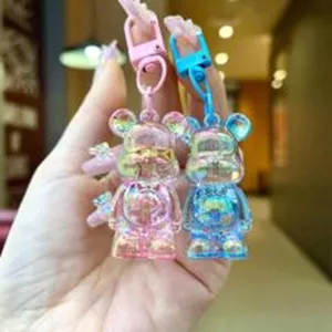 Detailed view of cute translucent iridescent bear keychains in pink and blue colors.