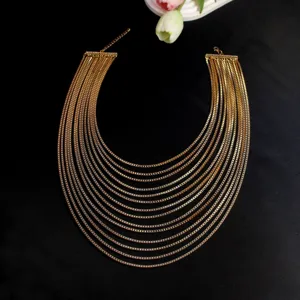 Detailed view of the multi-layer gold metal chain necklace, showcasing exquisite texture.