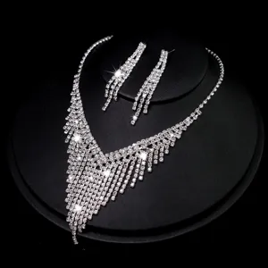 Detailed close-up of sparkling rhinestone fringe necklace and matching tassel earrings.