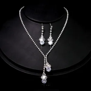 Bridal rhinestone necklace and dangling earrings set, Y-shaped crystal jewelry detail view.