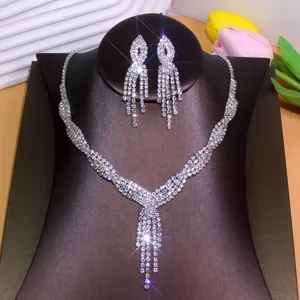 Close-up detail of the sparkling rhinestone tassel necklace and matching earrings jewelry set.