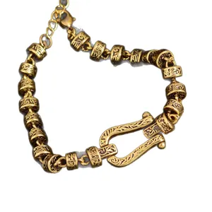 Vintage gold-tone horseshoe shackle bracelet with intricate carved tubular beads for women retro jewelry