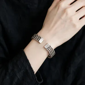 Vintage woven metal cuff bracelet for women, retro ethnic style wrist jewelry detail view.