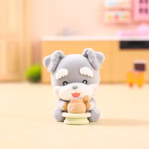 Close-up of cute grey flocked puppy toy figure holding a jar in miniature kitchen background.