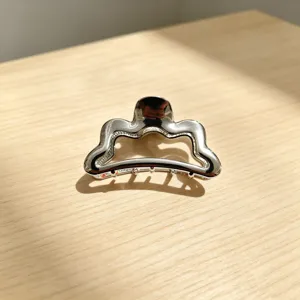Silver metal hair claw clip with unique wavy design, elegant shark clip for women and girls.