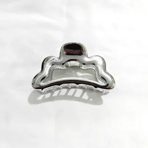 Silver metal hair claw clip for women, elegant wavy shark clip for styling thick hair updo.