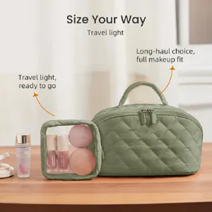 Detailed view of the quilted green cosmetic storage bag set with a clear front pouch on table.