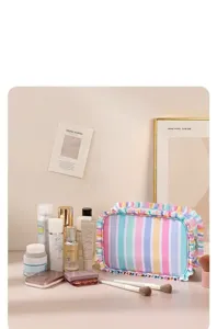 Cute striped ruffled cosmetic bag with large capacity, portable travel makeup storage pouch.