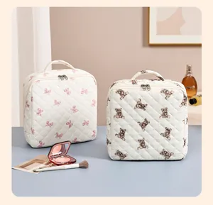 Quilted makeup bag with cute bear and bow print, large capacity portable travel organizer.