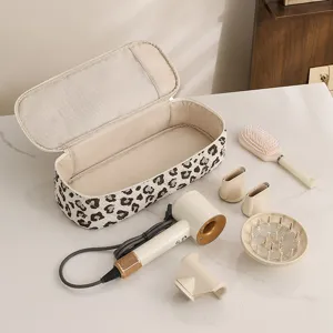 Multifunctional leopard hair dryer storage bag set with portable hair dryer and accessories.