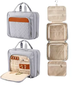 Detailed view of the multi-compartment travel cosmetic and jewelry organizer bag hanging open.