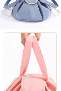 Close-up detail of the portable drawstring cosmetic bag, featuring durable fabric and handle.