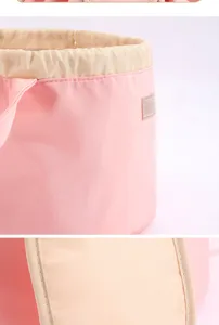 Close-up detail of pink travel makeup bag waterproof drawstring fabric and beige collar.