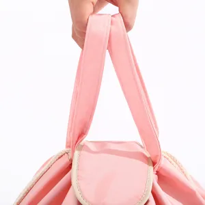 Portable pink drawstring cosmetic bag, large capacity travel toiletry storage pouch for women.