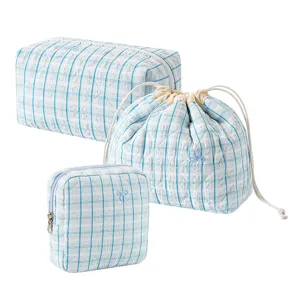 Cute blue plaid quilted cosmetic bag set with bow embroidery for travel and daily storage.