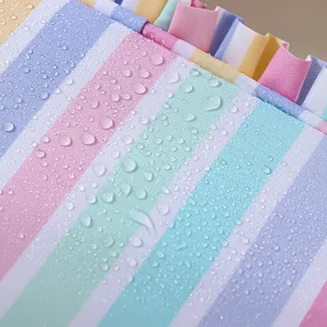 Sweet striped cosmetic bag with waterproof fabric and cute ruffled edge design for travel.