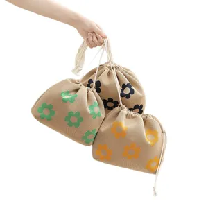 Canvas drawstring makeup bag with floral pattern, portable travel cosmetic storage pouch.